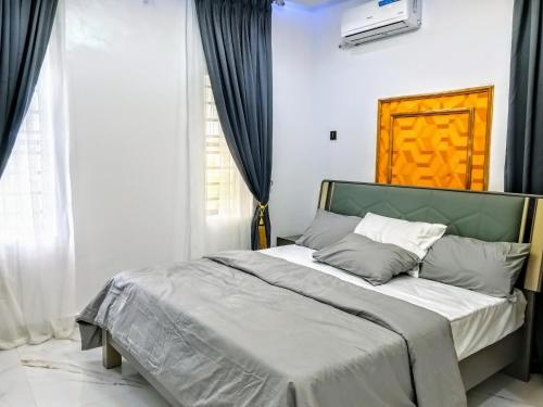 a bedroom with a large bed in front of a window at Aquamarine Premium 5 Bedroom Duplex in Lagos in Lekki