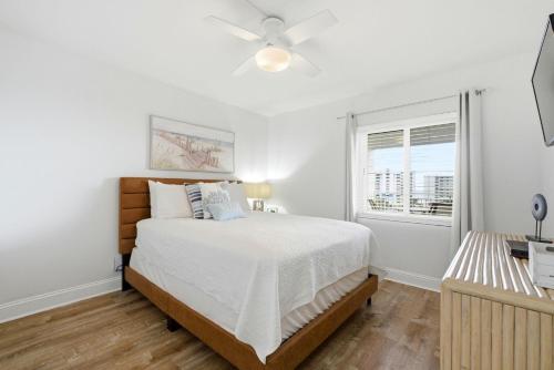 a white bedroom with a bed and a window at SeaSpray Riverside 712 in Perdido Key