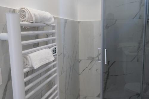 a bathroom with a shower with towels and a glass door at Renna's in Grammichele
