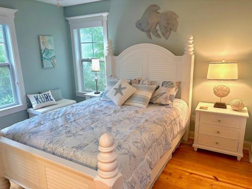 a bedroom with a large white bed with pillows at Happy Hours in Carolina Beach