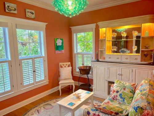 a living room with a couch and a table and windows at Happy Hours in Carolina Beach
