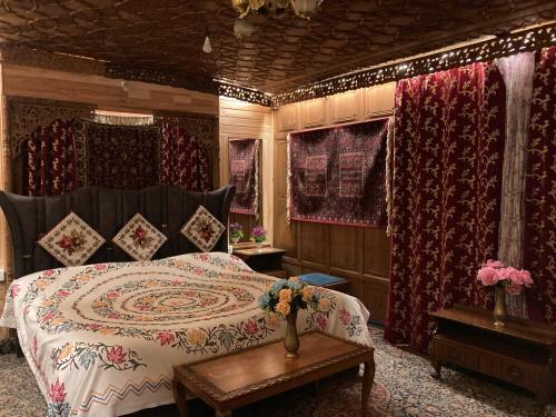 a bedroom with a bed and a table with flowers on it at Cheetah Palace in Srinagar
