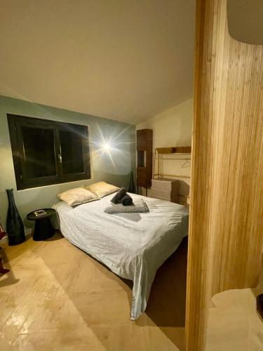 a bedroom with a large bed in a room at La Noirie in Saint-Étienne
