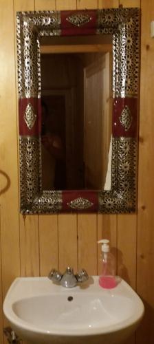 a bathroom sink with a mirror on the wall at La Chambre d hote in Ouarzazate