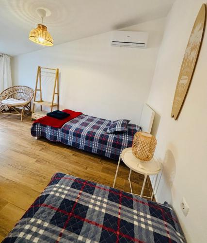a bedroom with a bed and a table and a chair at Cantinho do Alandroal in Alandroal