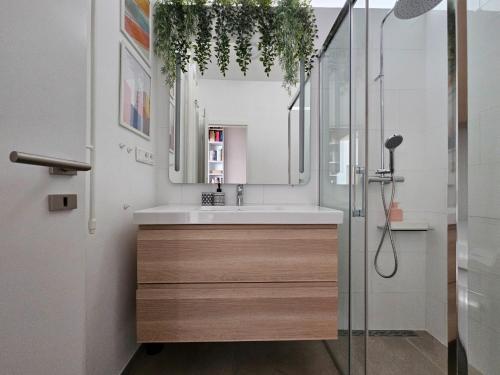 a bathroom with a sink and a shower at LAM Design Greenery AC - Balcony in Bratislava
