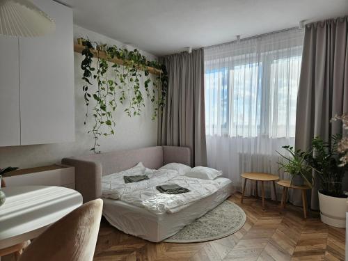 a bedroom with a bed in a room with a plant on the wall at LAM Design Greenery AC - Balcony in Bratislava