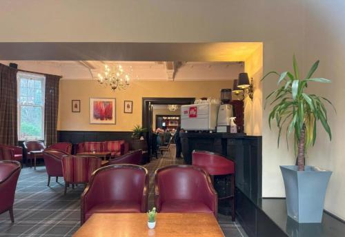 a restaurant with red leather chairs and a waiting room at Boann 5 - Hot Tub-Hunting Tower Lodges-Luxury-Families-Romantic in Perth