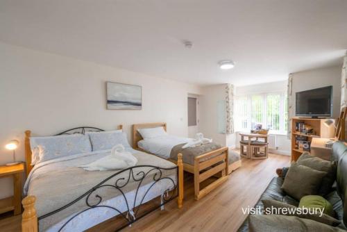 a bedroom with a bed and a couch at Personal En-suite in Shrewsbury