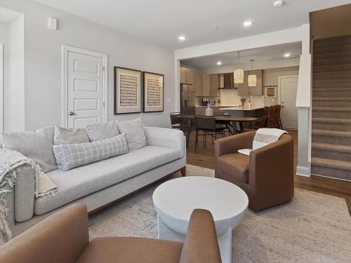 a living room with a couch and a table at Luxe King Bed, Balcony, Garage in Downtown Raleigh in Raleigh