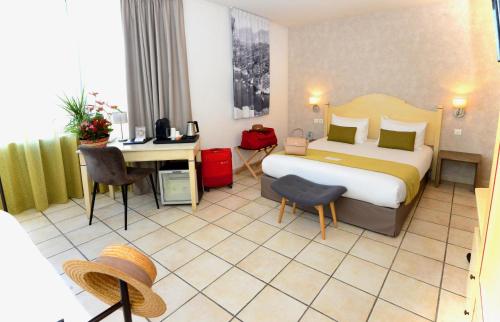 a hotel room with a bed and a desk at Sure Hotel by Best Western Gemenos en Provence in Gémenos