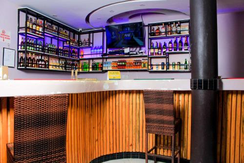 a bar with a lot of bottles of alcohol at Moto-Moto Cottages in Mbarara