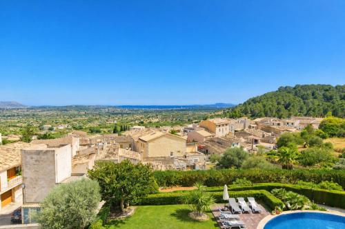 a villa with a swimming pool and a resort at Villa Nobleza, oasis con piscina y gimnasio a 2 min del centro in El Port de la Selva