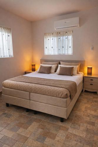 a bedroom with a large bed with two night stands at Apartments Diva Flamingo in Barber