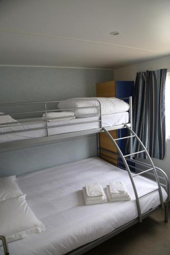 a bunk bed with two mattresses on top of it at Parque de Campismo Orbitur Canidelo in Vila Nova de Gaia