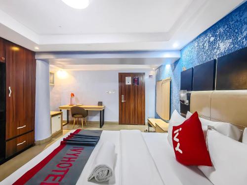 a hotel room with a bed and a desk at Aotel Hotels & Suites - Ojota in Lagos