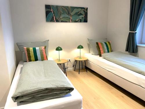 two beds in a room with two lamps on tables at Ferienhaus Landliv Huus - mit Familienbett & Spielzimmer in Husby