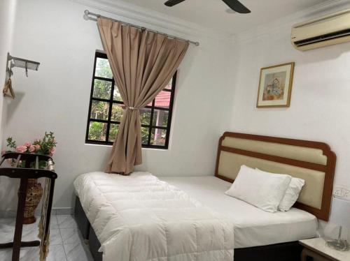 a bedroom with two beds and a window at Msy Residence in Shah Alam