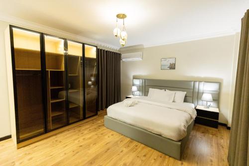 a bedroom with a bed and a large window at Deluxe Ocean Apartment Heliopolis in Cairo
