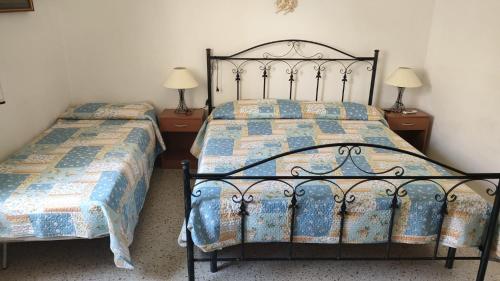 a bedroom with two beds and two night stands at Borgo marino litorale salus in Sciacca