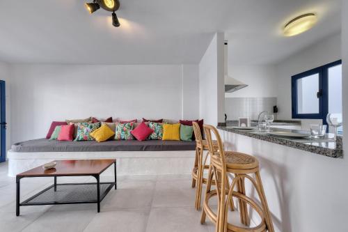 a living room with a bed with colorful pillows at Casa Eva in Famara