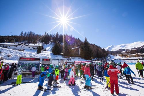 a group of people on skis in the snow at Club Esse Pila 2000 in Pila