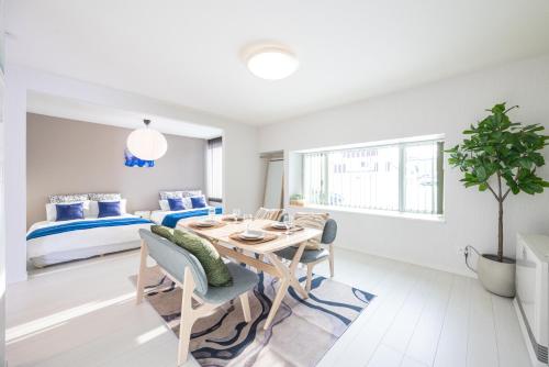 a living room with a dining room table and a bedroom at BIEI BREEZE RESERVE Sui 水 in Biei