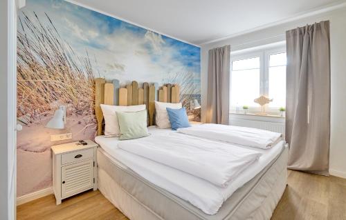 a bedroom with a large bed with a painting on the wall at Hotel Deichgraf in Cuxhaven