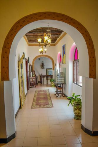 an arched hallway with an archway in a house at Tembo House Hotel in Zanzibar City