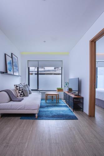 a living room with a couch and a table at Ariama Serviced Residence in Jakarta