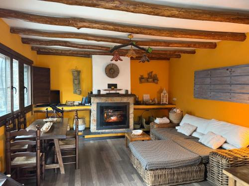 a living room with a couch and a fireplace at CASA RURAL CORTIJO MOLINO ALTERO in Trevélez