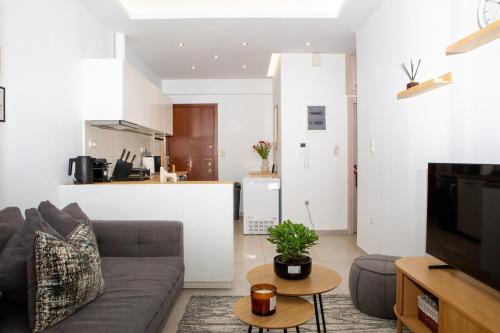 a living room with a couch and a kitchen at E25 by SpitiSou in Athens