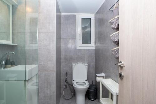a small bathroom with a toilet and a sink at E25 by SpitiSou in Athens