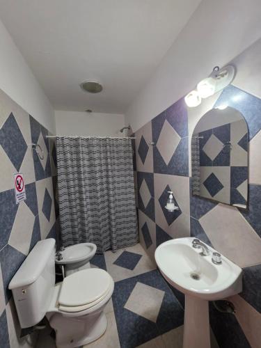 a bathroom with a toilet and a sink at Complejo de departamentos 7 Cielos in Villa Carlos Paz