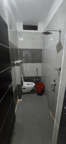 a bathroom with a toilet and a sink at Hotel Shri Hari Har Inn in Godarpura