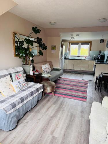 a living room with a couch and a table at “A Wee Pad in Dunfermline” in Dunfermline