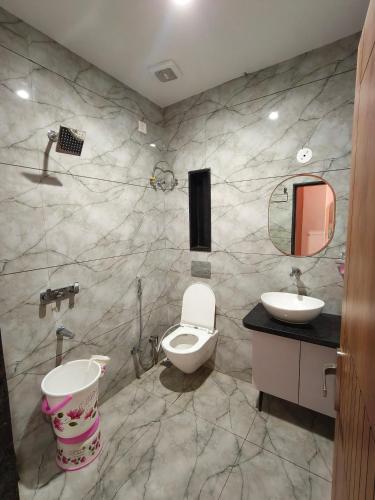 a bathroom with a toilet and a sink at Hotel Kanak Shree in Godarpura