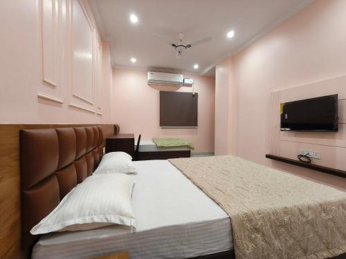 a bedroom with a bed and a flat screen tv at Hotel Kanak Shree in Godarpura
