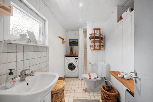 a bathroom with a sink and a washing machine at LL267-Tranekaer-Bellisvej-2 in Stoense