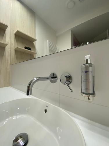 a bathroom with a white sink and a mirror at Hotel Cztery Korony in Śrem