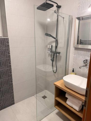 a bathroom with a shower and a sink at Contact Apartman in Bardejov