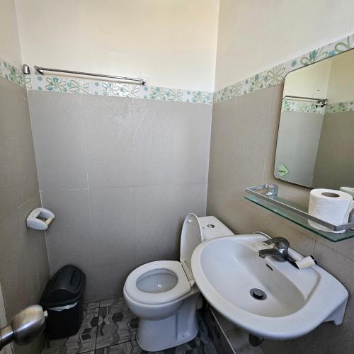 a bathroom with a white toilet and a sink at One oasis condo 1bedroom Ltype in Davao City