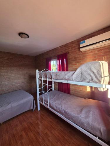 a bedroom with two bunk beds and a window at Complejo de departamentos 7 Cielos in Villa Carlos Paz