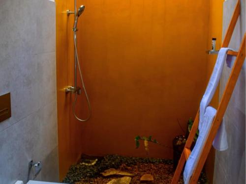 a bathroom with a shower and a toilet in a room at Mount Lily Mirissa in Mirissa