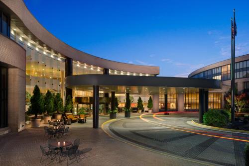 a large building with tables and chairs in front of it at DoubleTree by Hilton Washington Dulles Airport in Herndon
