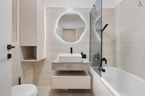 a bathroom with a sink and a toilet and a tub at Studio in Dimri Residence in Bucharest