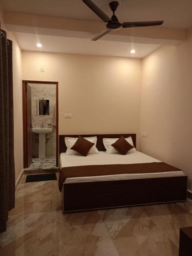 a bedroom with a bed with a ceiling fan at Chill with pahadi in Lansdowne