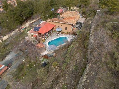 an aerial view of a house with a swimming pool at Fikardou Chalets in Phikardhou