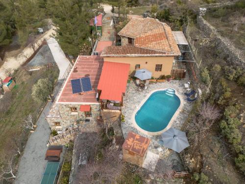 an aerial view of a house with a swimming pool at Fikardou Chalets in Phikardhou