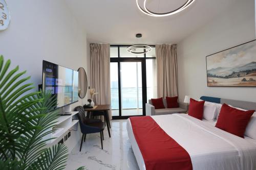a hotel room with a bed and a desk and a room at Modern Waterfront Studio | Steps from Cleveland Clinic in Abu Dhabi